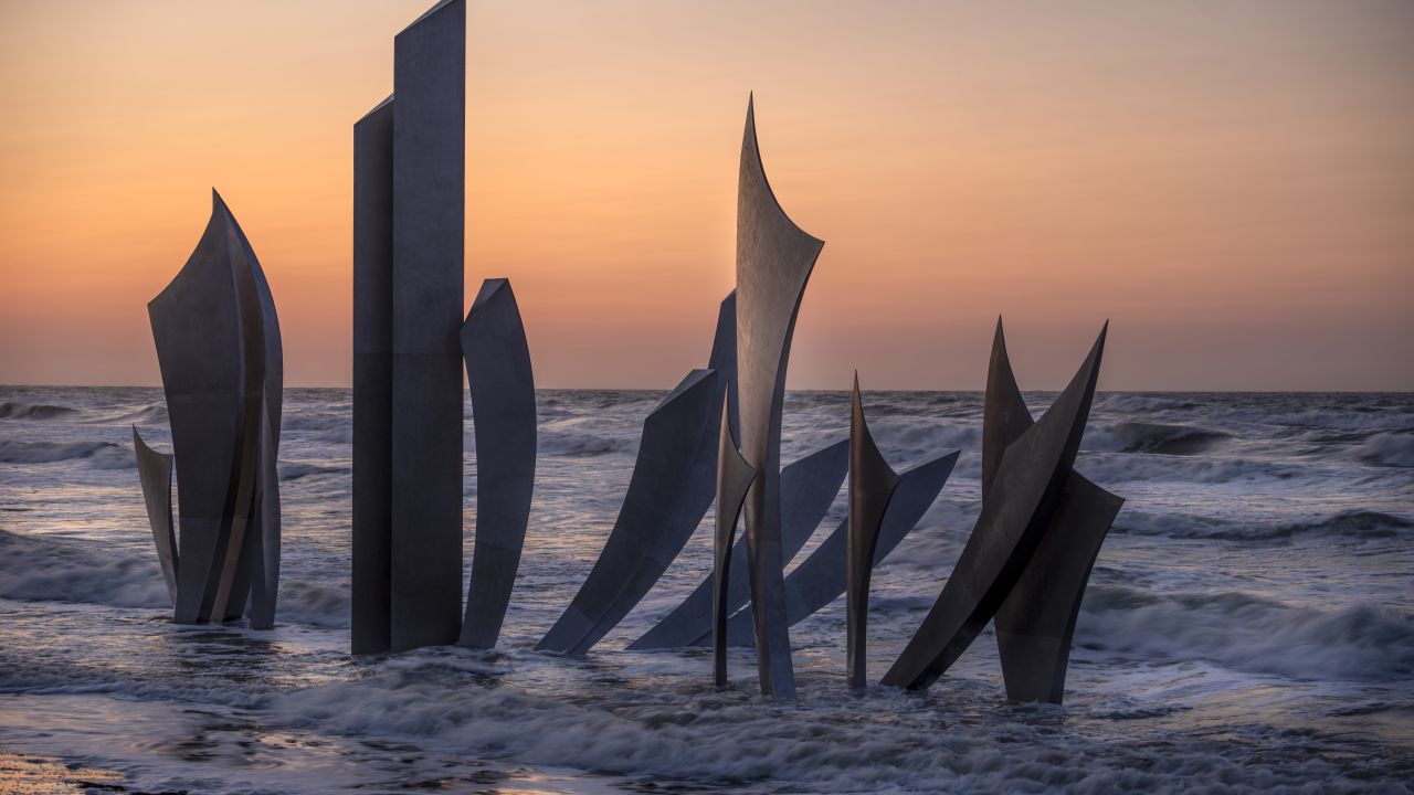 COLLEVILLE-SUR-MER, FRANCE - JUNE 04: The sun sets behind the Omaha Beach D-Day monument 'Les Braves' ahead of D-Day commemorations on June 04, 2023 in Colleville-sur-Mer, France. This week marks the 79th anniversary of the Allied invasion of Normandy during World War II, in an operation to liberate France from occupation by Nazi Germany, a pivotal moment in the war. (Photo by Christopher Furlong/Getty Images)