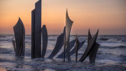 COLLEVILLE-SUR-MER, FRANCE - JUNE 04: The sun sets behind the Omaha Beach D-Day monument 'Les Braves' ahead of D-Day commemorations on June 04, 2023 in Colleville-sur-Mer, France. This week marks the 79th anniversary of the Allied invasion of Normandy during World War II, in an operation to liberate France from occupation by Nazi Germany, a pivotal moment in the war. (Photo by Christopher Furlong/Getty Images)