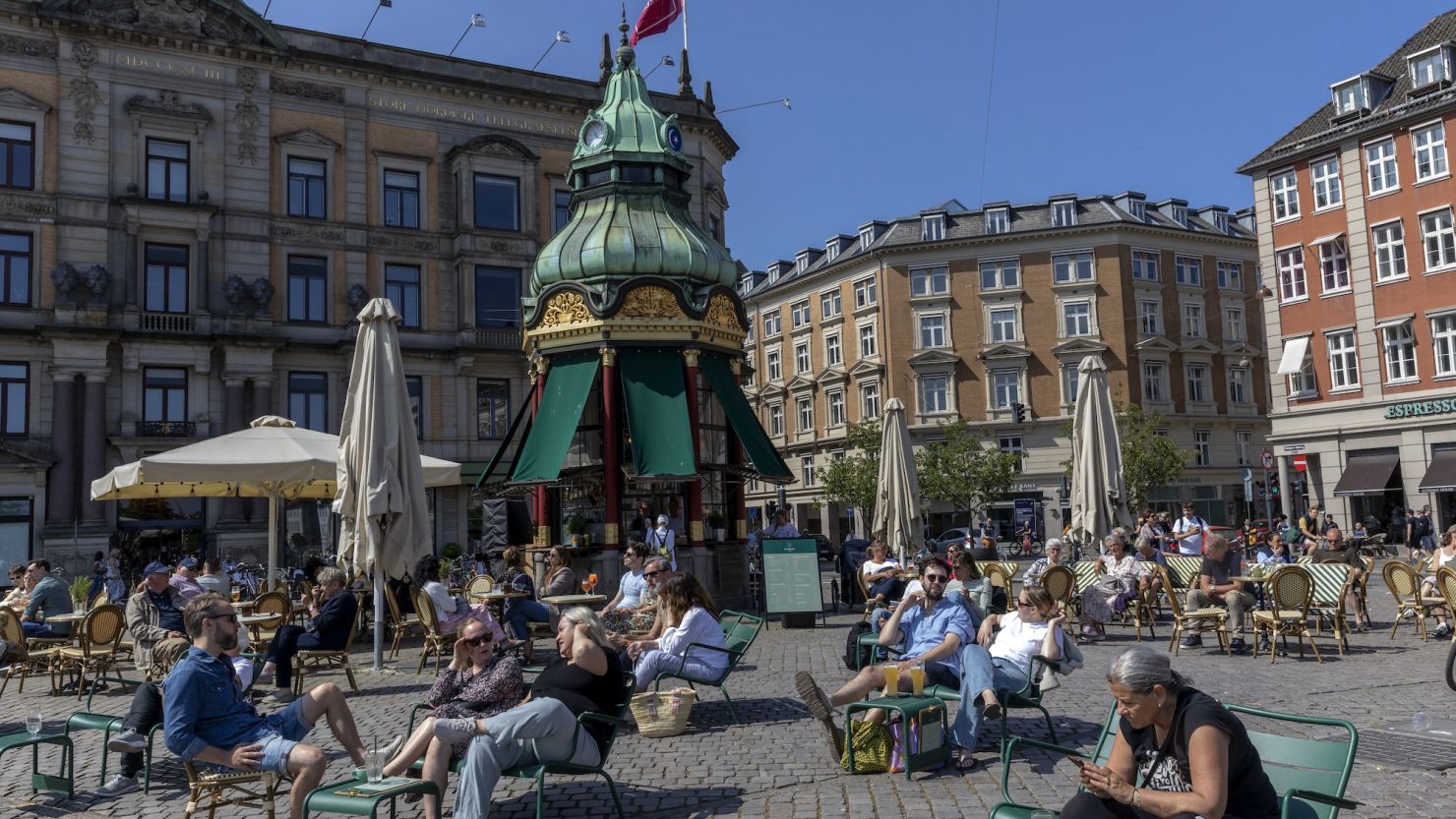 Cafe customers soak up the sun in the Danish capital, Copenhagen, in June 2023.