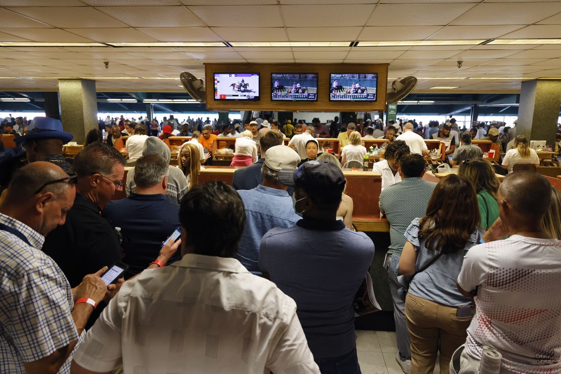 Fans line up at the betting booth prior to the 155th running of the Belmont Stakes at Belmont Park in 2023.