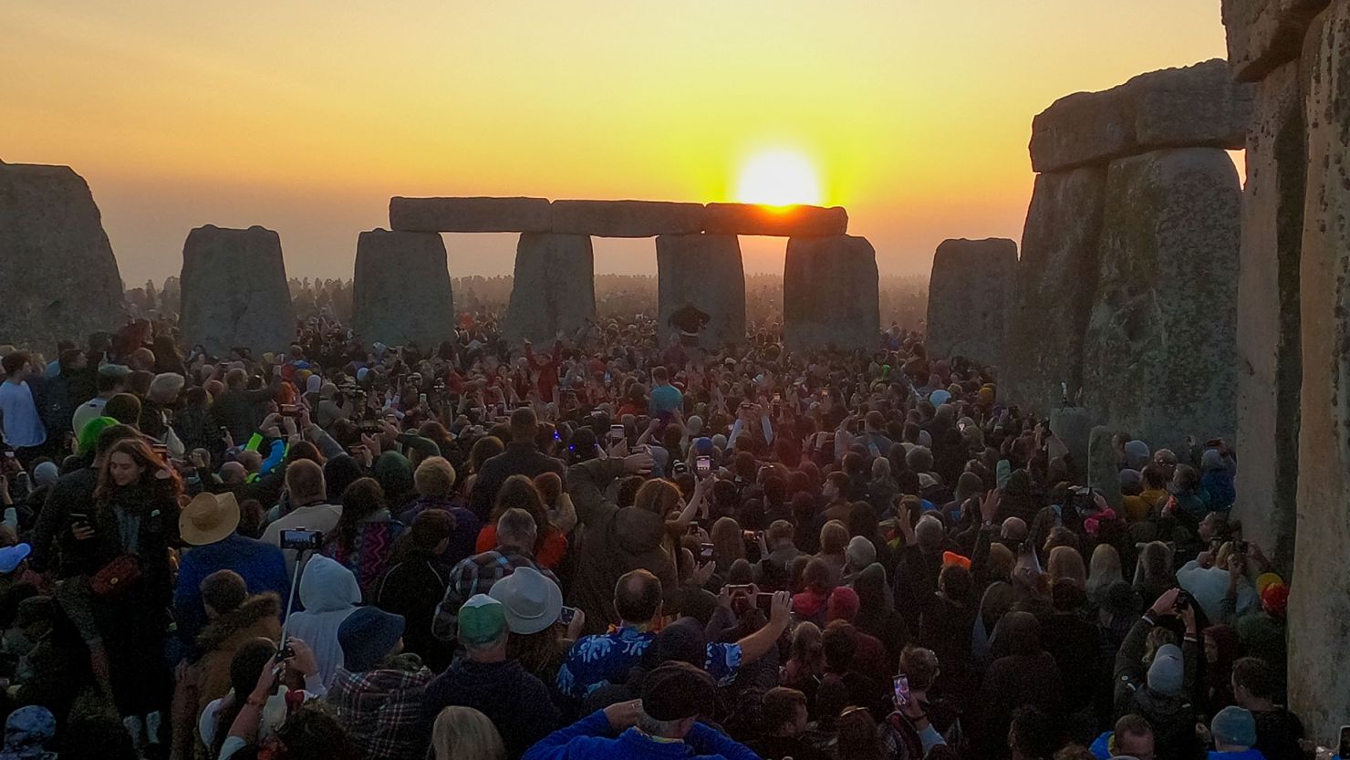 Throngs of visitors welcome the sun at Stonehenge during the summer solstice on June 21, 2023.