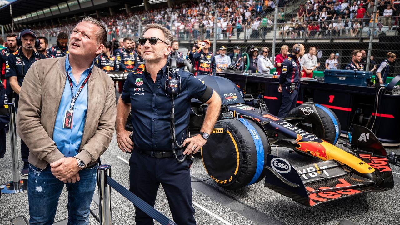 Jos Verstappen and Christian Horner stand on the grid in Austria last year.