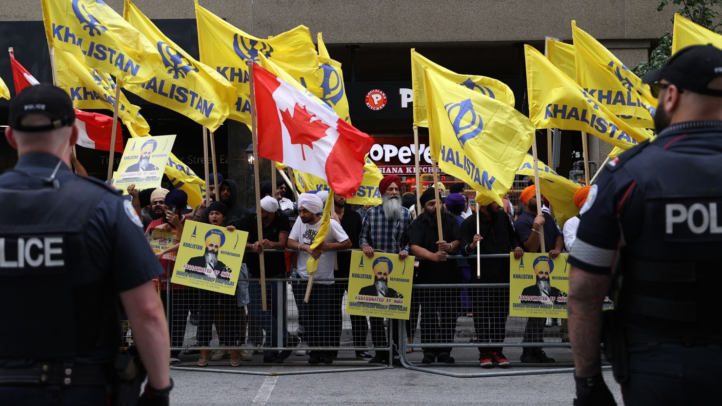 Police officers stand guard as Pro-Khalistan supporters demonstrate in front of the Indian Consulate in Toronto, Ontario, in July 2023.