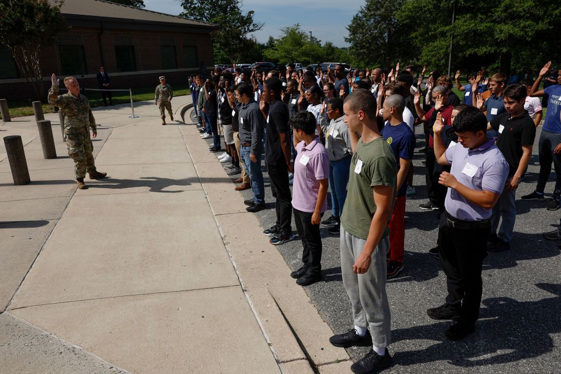 Military recruits practice taking the oath of enlistment before a ceremony with Secretary of Defense Lloyd Austin on July 5, 2023, at Fort Meade, Maryland. Austin attended the ceremony to administer the oath marking 50 years of the military being an all-volunteer service.