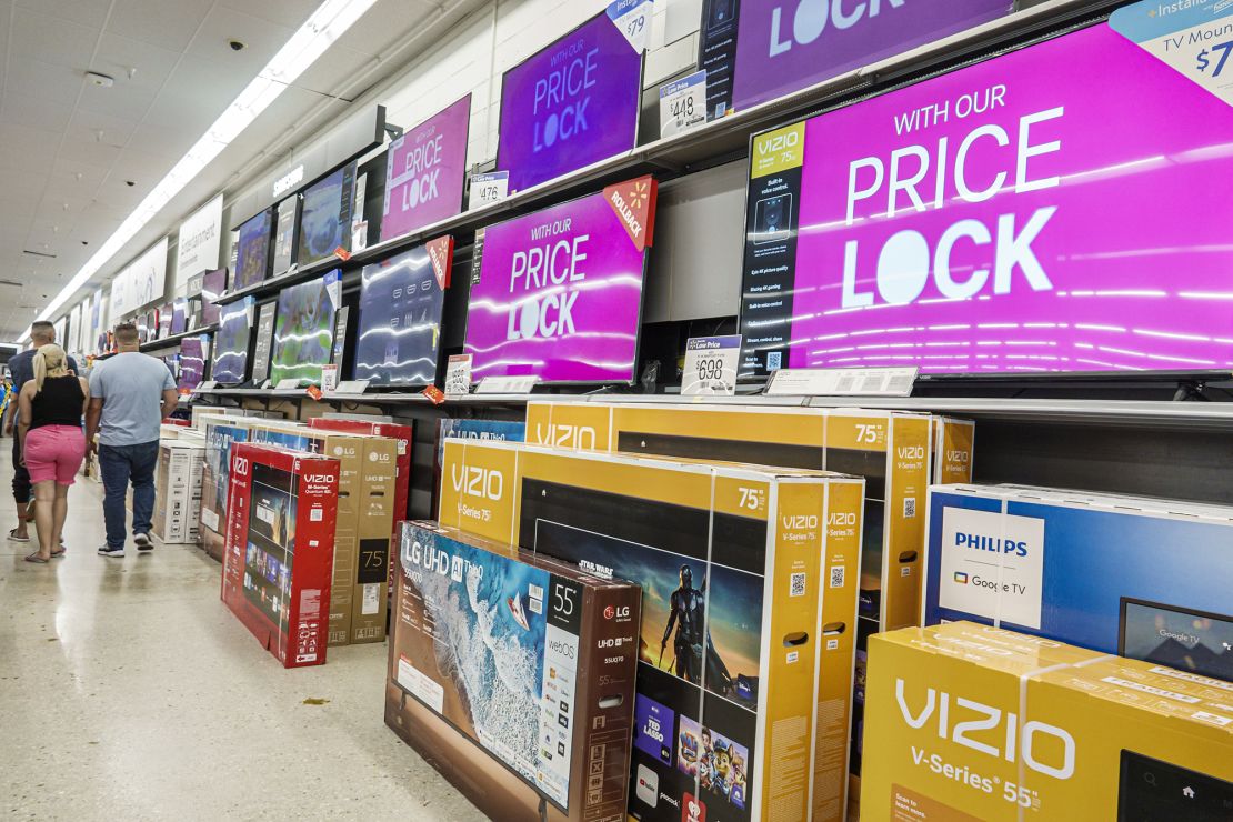 Wide screen flat digital TVs on display at a Walmart store in Miami, Florida, on March 29, 2023.