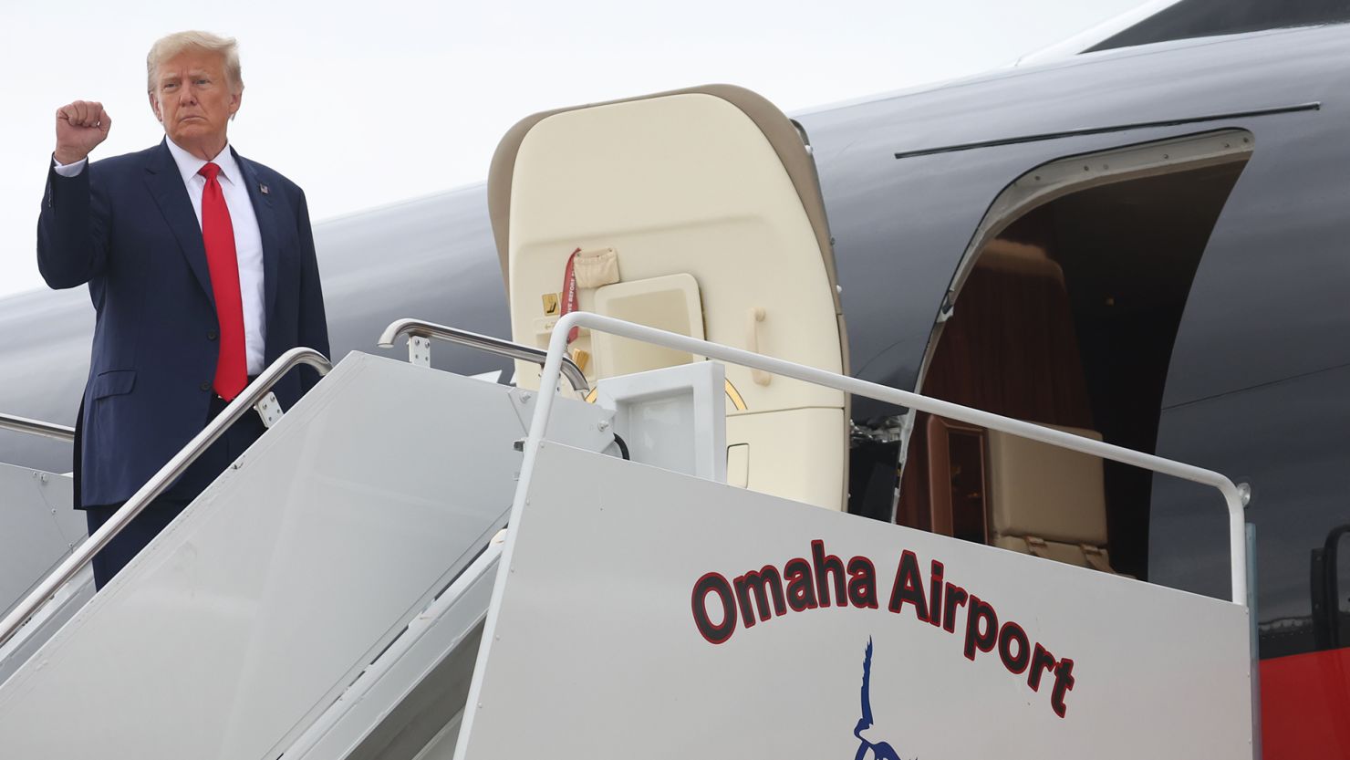 Former US President Donald Trump prepares to board his jet at the airport after holding a campaign event in Nearby Council Bluffs, Iowa on July 07, 2023 in Omaha, Nebraska.