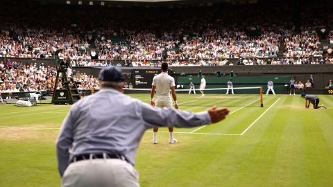 A line judge calls out during the men's singles quarter final match between Novak Djokovic of Serbia and Andrey Rublev during The Championships Wimbledon 2023 at All England Lawn Tennis and Croquet Club in London on July 11, 2023.