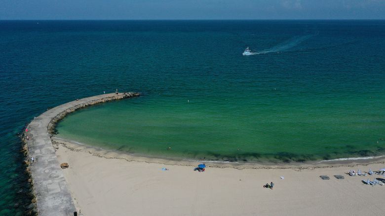 MIAMI, FLORIDA - JULY 11:  In an aerial view, a boat arrives at the Haulover inlet from the Atlantic Ocean to on July 11, 2023 in Miami, Florida. The surface ocean temperatures in parts of Florida are 92 to 96 degrees Fahrenheit, the warmer coastal ocean water is threatening Florida's coral reefs, and could create stronger tropical storms and hurricanes. (Photo by Joe Raedle/Getty Images)