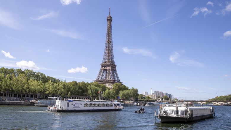 PARIS, FRANCE - JULY 17: An empty boat travels the river Seine during the technical test event for the Paris 2024 opening ceremony with the Eiffel Tower in the background on July 17, 2023 in Paris, France. On July 26, 2024, for the first time in the history of the Summer Olympic Games, the opening ceremony will not be taking place in a stadium. The parade of athletes will be held on the Seine, with boats for each national delegation. Wending their way from east to west the parade will come to the end of its 6 km route in front of the Trocadéro, where the remaining elements of the Olympic protocol and final shows will take place. (Photo by Catherine Steenkeste/Getty Images)