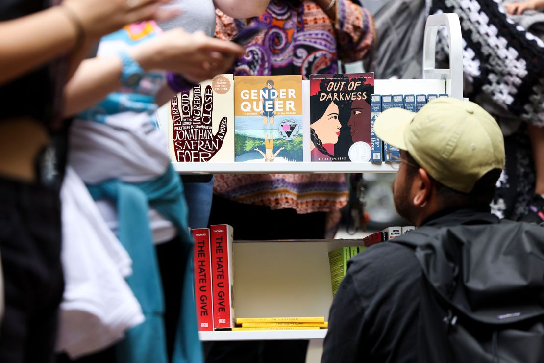 A person looks at the free banned books during the MoveOn "Banned Bookmobile" Tour stop outside of Sandmeyer's Bookstore in the South Loop on July 13, 2023.