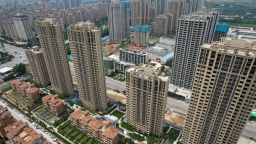 This photo taken on June 20, 2023 shows an aerial view of a complex of unfinished apartment buildings in Xinzheng City in Zhengzhou, China's central Henan province. China's real estate industry grew at lightning speed from the late 90s, and was a major component of the country's turbocharged economic expansion. But with growth slowing and debts swelling, authorities cut off access to easy loans in 2020, pummelling the sector and causing a record-breaking slump last year. 
A wave of mortgage boycotts spread nationwide last summer, as cash-strapped developers struggled to raise enough to complete homes they had already sold in advance -- a common practice in China. (Photo by Pedro PARDO / AFP) (Photo by PEDRO PARDO/AFP via Getty Images)