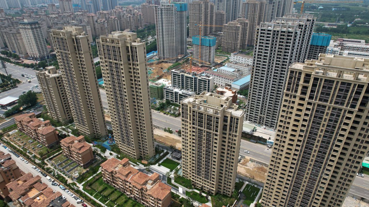 This photo taken on June 20, 2023 shows an aerial view of a complex of unfinished apartment buildings in Xinzheng City in Zhengzhou, China's central Henan province. China's real estate industry grew at lightning speed from the late 90s, and was a major component of the country's turbocharged economic expansion. But with growth slowing and debts swelling, authorities cut off access to easy loans in 2020, pummelling the sector and causing a record-breaking slump last year. 
A wave of mortgage boycotts spread nationwide last summer, as cash-strapped developers struggled to raise enough to complete homes they had already sold in advance -- a common practice in China. (Photo by Pedro PARDO / AFP) (Photo by PEDRO PARDO/AFP via Getty Images)