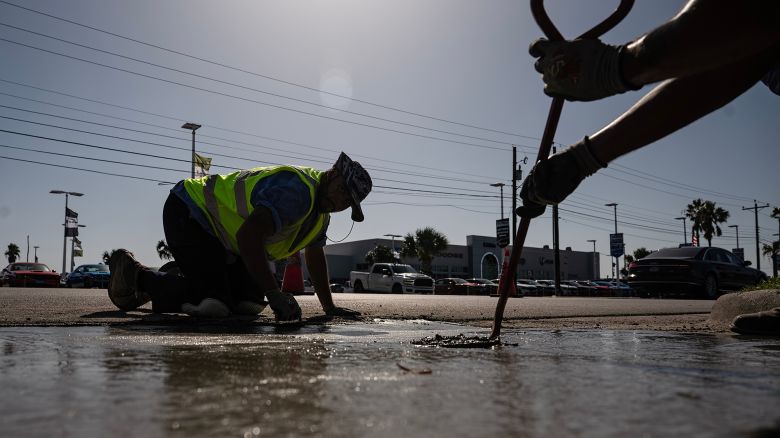 Construction workers do street repair during a heat wave in Corpus Christi, Texas, US, on Thursday, July 20, 2023. Heat advisories and excessive heat warnings stretch from California's Central Valley to Miami.