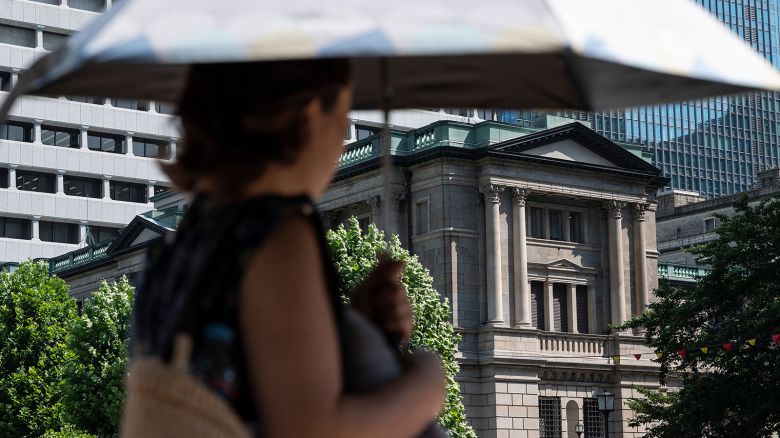 A pedestrian walks past the Bank of Japan building in Tokyo.