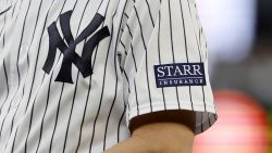 NEW YORK, NEW YORK - JULY 21:  A sponsor logo is seen on the sleeve of the uniform of first base coach Travis Chapman #75 of the New York Yankees during a game against the Kansas City Royals at Yankee Stadium on July 21, 2023 in Bronx borough of New York City. (Photo by Jim McIsaac/Getty Images)