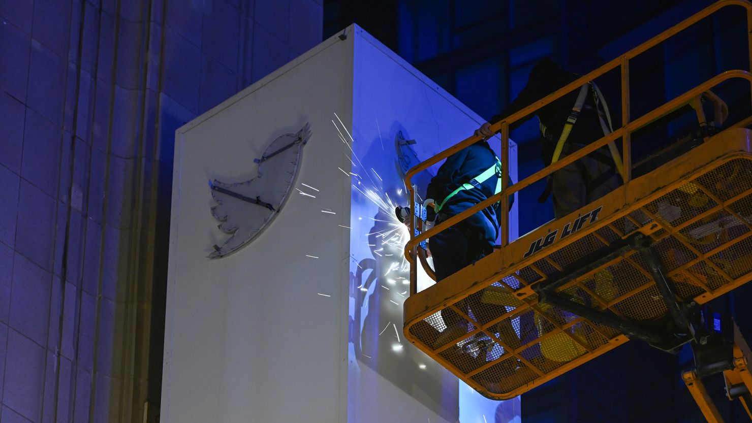 Workers take the blue bird logo and letters off of Twitter sign as the ''X'' sign was installed on the top of Twitter's headquarters in San Francisco, California, on July 29, 2023, following Elon Musk's takeover.