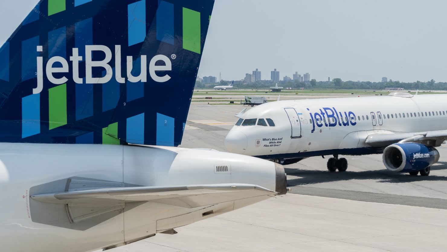 JetBlue airplanes wait on the tarmac at John F. Kennedy International Airport in June 2023.