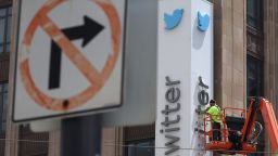 A worker removes letters from the Twitter sign on the exterior of the company's headquarters in San Francisco, California on July 24, 2023 after Elon Musk rebranded Twitter to X.