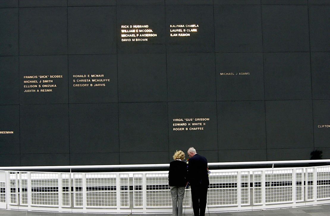 TOPSHOT - The wife of space shuttle Columbia Commander Rick Husband, Evelyn Husband (L), and NASA Associate Administrator Bill Readdy (R) place a wreath 28 October, 2003, at the Astronaut Memorial on Kennedy Space Center, Florida during a dedication adding the Columbia crew (top). The space shuttle Columbia and her seven person crew were lost over Texas 01 February during their return to Earth. AFP PHOTO/BRUCE WEAVER (Photo by BRUCE WEAVER / AFP) (Photo by BRUCE WEAVER-/AFP via Getty Images)