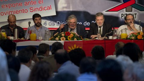 Uruguayan President Jose Mujica (C) speaks accompanied by his ministers of Industry, Energy and Mines, Roberto Kreimerman (2nd- R), Social Development, Daniel Olesker (R) and Uruguayan PIT-CNT (Union Federation) coordinators Marcelo Abdala (L) and Fernando Pereira (2nd-L) during a working breakfast at the headquarters of the PIT-CNT Uruguayan labor union federation in Montevideo on December 4, 2012. AFP PHOTO/Pablo PORCIUNCULA (Photo credit should read PABLO PORCIUNCULA/AFP via Getty Images)