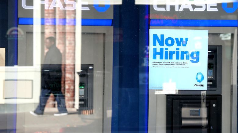 SAN RAFAEL, CA - JANUARY 04: A pedestrian walks by a "now hiring" sign that is posted in the window of a Chase bank branch on January 4, 2013 in San Rafael, California. According to a Labor Department December jobs report, the U.S. unemployment remained the same from November at 7.8% as employers added 155,000 jobs in December.  (Photo by Justin Sullivan/Getty Images)