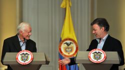 Former US president and 2002 Nobel peace prize laureate, Jimmy Carter (L) smiles with Colombian President Juan Manuel Santos (R) during a meeting on January 12, 2013, at Narino Presidential Palace in Bogota, Colombia. Carter is on a two day visit to Bogota to assess the ongoing peace talks between Colombia's government and its largest leftist guerrilla group, the Revolutionary Armed Forces of Colombia (FARC). This meeting will take place before the government delegation's trip to Havana on Monday to resume talks with FARC's delegation and start the third round of peace negotiations. AFP PHOTO/Guillermo LEGARIA        (Photo credit should read GUILLERMO LEGARIA/AFP via Getty Images)