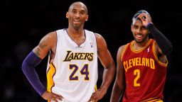 Kobe Bryant (left) and Kyrie Irving (right) look on during a game between the Los Angeles Lakers and the Cleveland Cavaliers in 2013.
