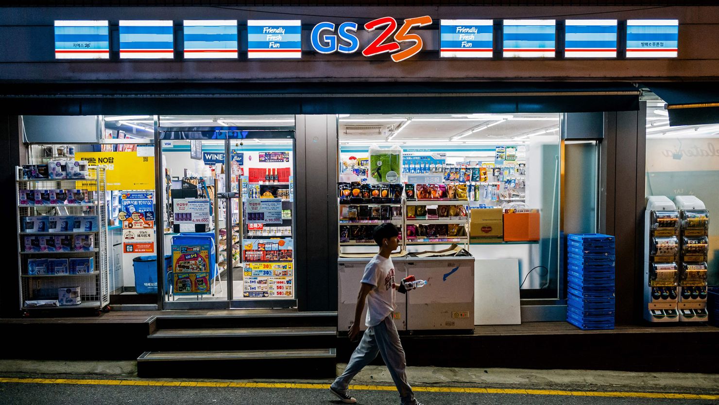 A man walks past a GS25 convenience store in Seoul on August 18, 2023.