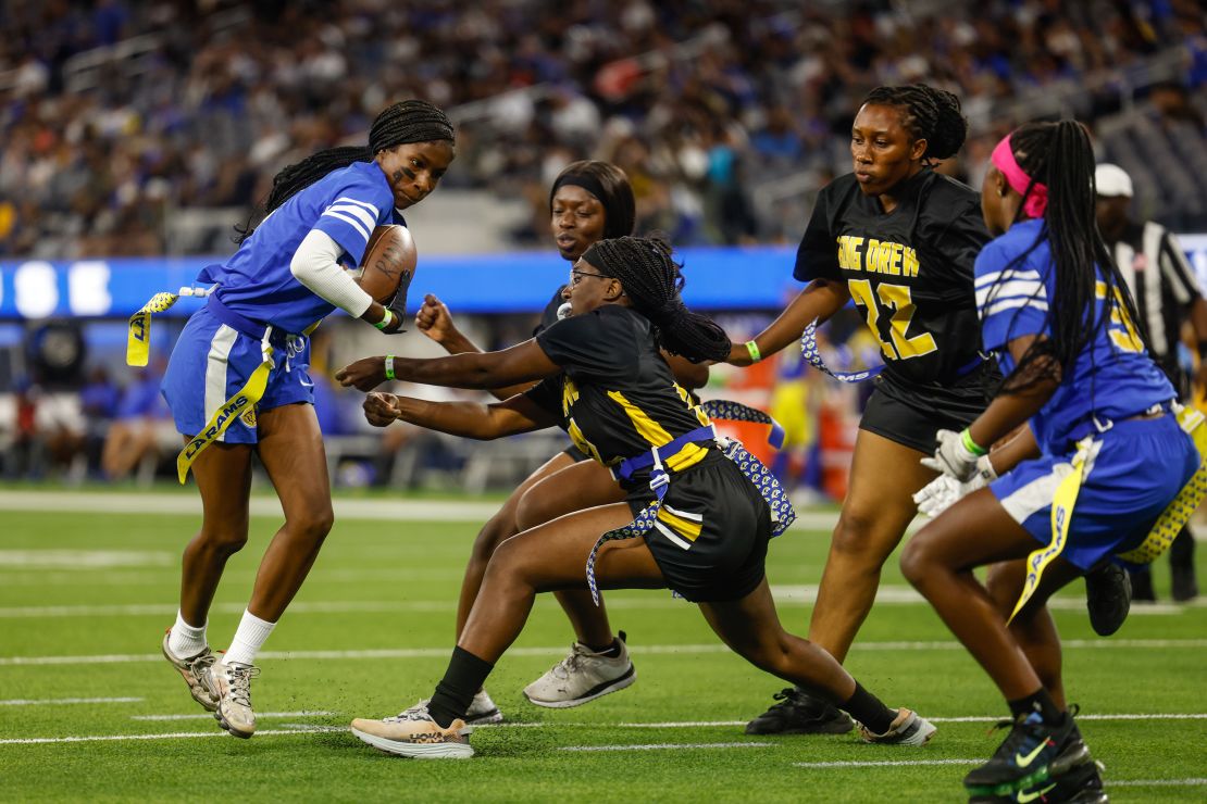 Inglewood, CA - August 19: A player for for Crenshaw girls flag football runs the ball as they play King/Drew at halftime of the Rams and Raiders preseason game at SoFi Stadium on Saturday, Aug. 19, 2023 in Inglewood, CA. (Jason Armond / Los Angeles Times via Getty Images)