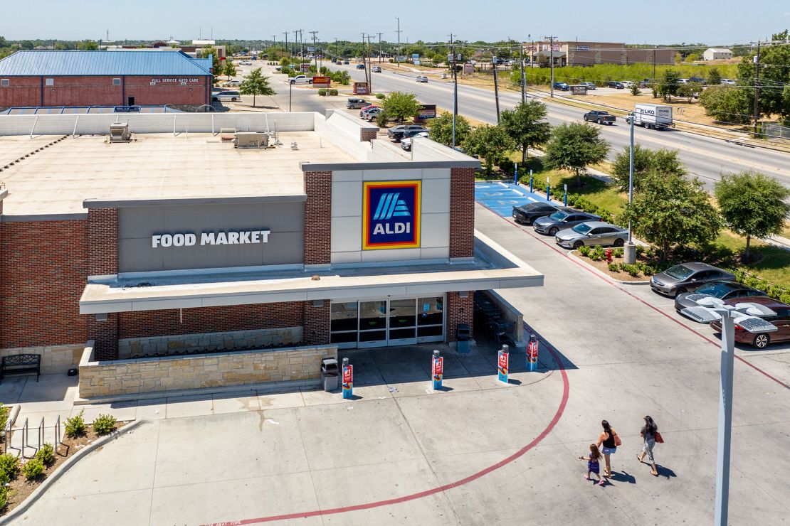 A family walks into an Aldi supermarket on August 17, 2023 in Pflugerville, Texas. The German Supermarket acquired Winn-Dixie, Harveys Supermarkets and other grocery stores in the Southeast in an attempt to increase its presence in the region.