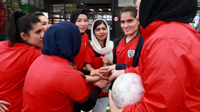 Nobel Peace Prize winner Malala Yousafzai is seen in the huddle during a football game with members of the Afghan Women's Team at Ultra Football, in Melbourne, on August 19, 2023.