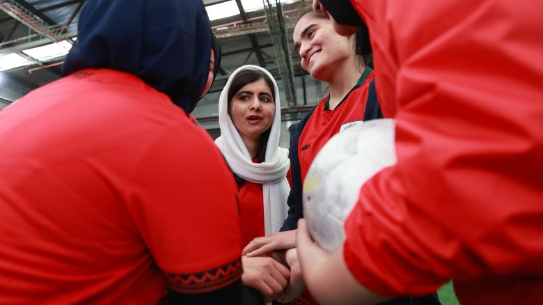 MELBOURNE, AUSTRALIA - AUGUST 19: Nobel Peace Prize winner Malala Yousafzai is seen in the huddle during a football game with members of the Afghan Women's Team at Ultra Football on August 19, 2023 in Melbourne, Australia. (Photo by Kelly Defina/Getty Images)