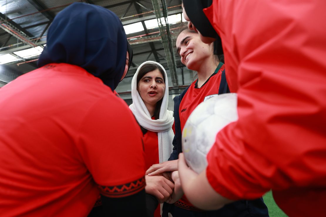Yousafzai is seen in a huddle with members of the Afghan women's soccer team in August 2023.