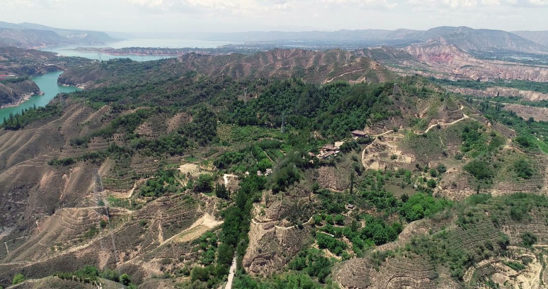 Green mountains and the blue-green waters of the Yellow River on the Loess Plateau in Yongjing, Gansu province, China, July 24, 2023.