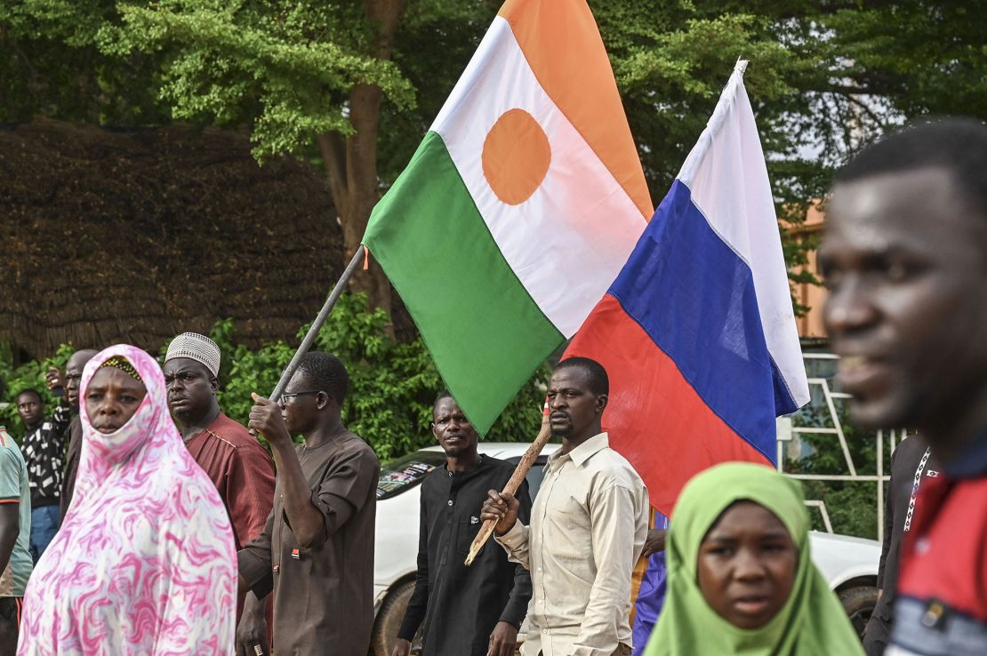 Supporters of Niger's National Council for Safeguard of the Homeland (CNSP) hold up Niger's national flag and the national flag of Russia at the General Seyni Kountche stadium in Niamey on Agust 26, 2023.