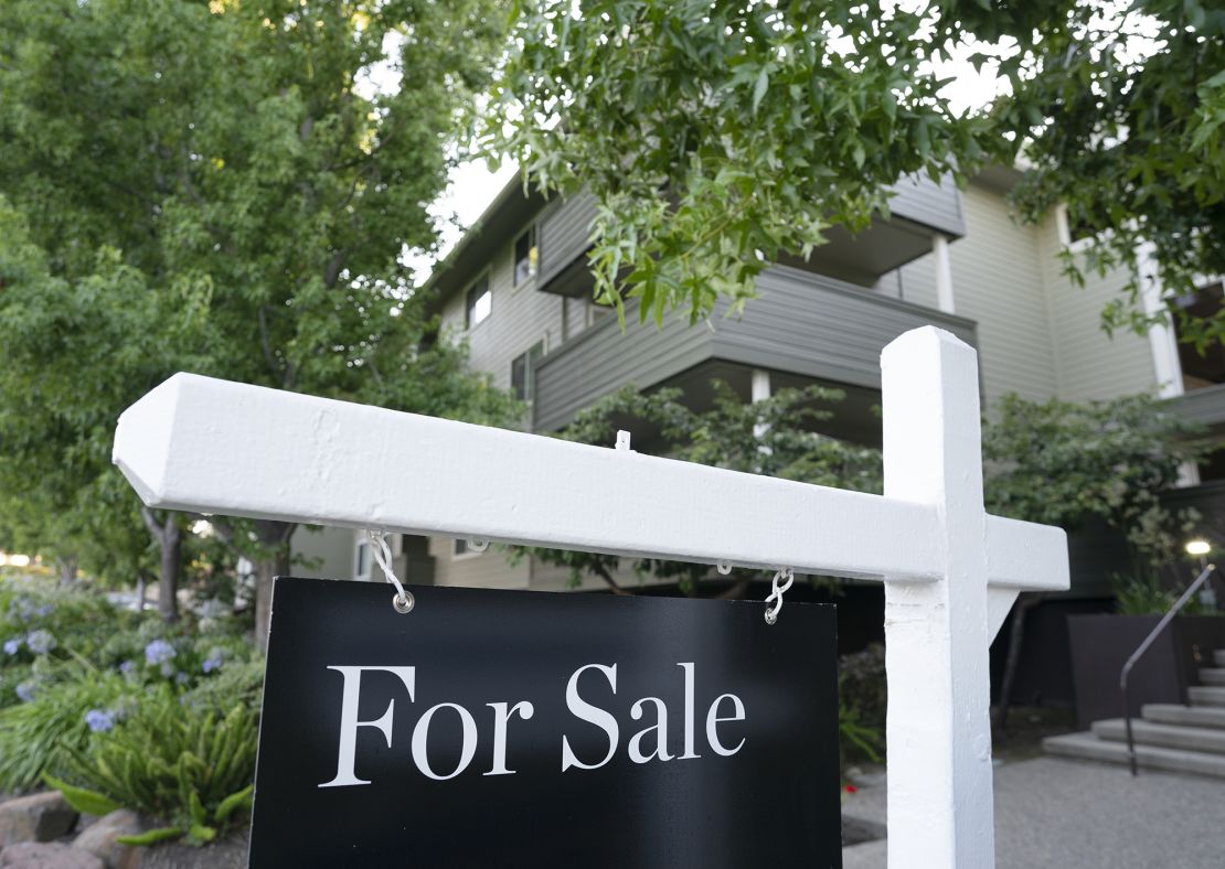 A for sale sign hangs in front of a home on August 22, 2023 in San Mateo County, California.