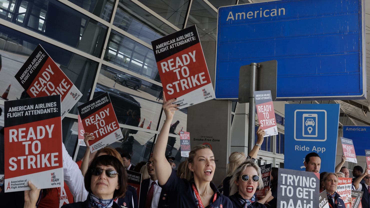 American Airlines flight attendants conduct an informational picket outside Dallas-Fort Worth International Airport on August 30, 2023. On Monday the union asked that an impasse be declared in its negotiations with American.