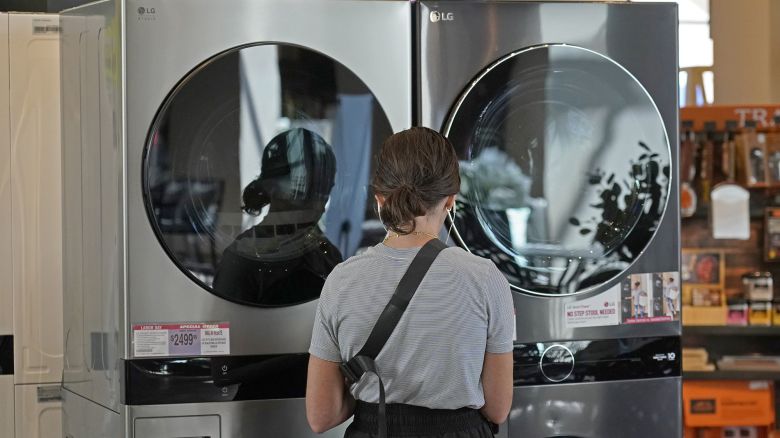 A customer looks at LG washing machines and dryers.