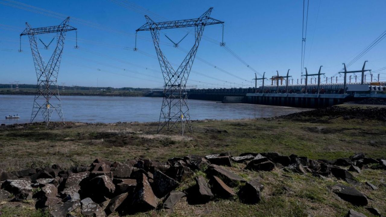 High voltage pylons located in the Uruguayan department of Salto and the Salto Grande binational hydroelectric dam (R) on the Uruguay River between Salto in Uruguay and Concordia in Argentina, are seen on August 30, 2023. (Photo by Pablo PORCIUNCULA / AFP) (Photo by PABLO PORCIUNCULA/AFP via Getty Images)