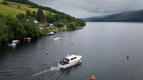 DRUMNADROCHIT, SCOTLAND - AUGUST 27: Nessie hunters board a boat on Loch Ness for what is being described as the biggest search for the Loch Ness Monster since the early 1970's being held this weekend on August 27, 2023 in Drumnadrochit Scotland. Over Saturday and Sunday, hundreds of Nessie enthusiasts are taking part in the biggest organised hunt for the mysterious creature in 50 years. Most of the volunteer Nessie-hunters are onshore or watching a livestream, while a smaller team has taken to the water with acoustic listening equipment and other devices to aid the search. (Photo by Jeff J Mitchell/Getty Images)