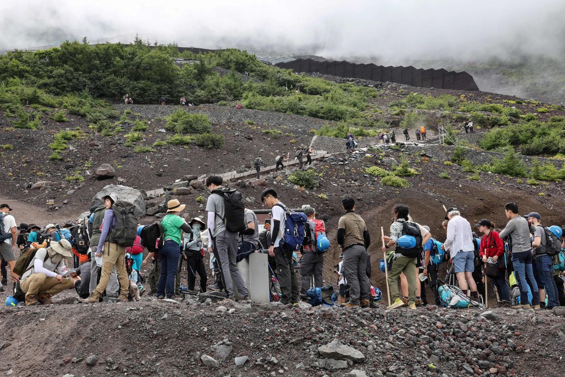 This 2023 photo shows a crowd of visitors beginning their Mount Fuji ascents.