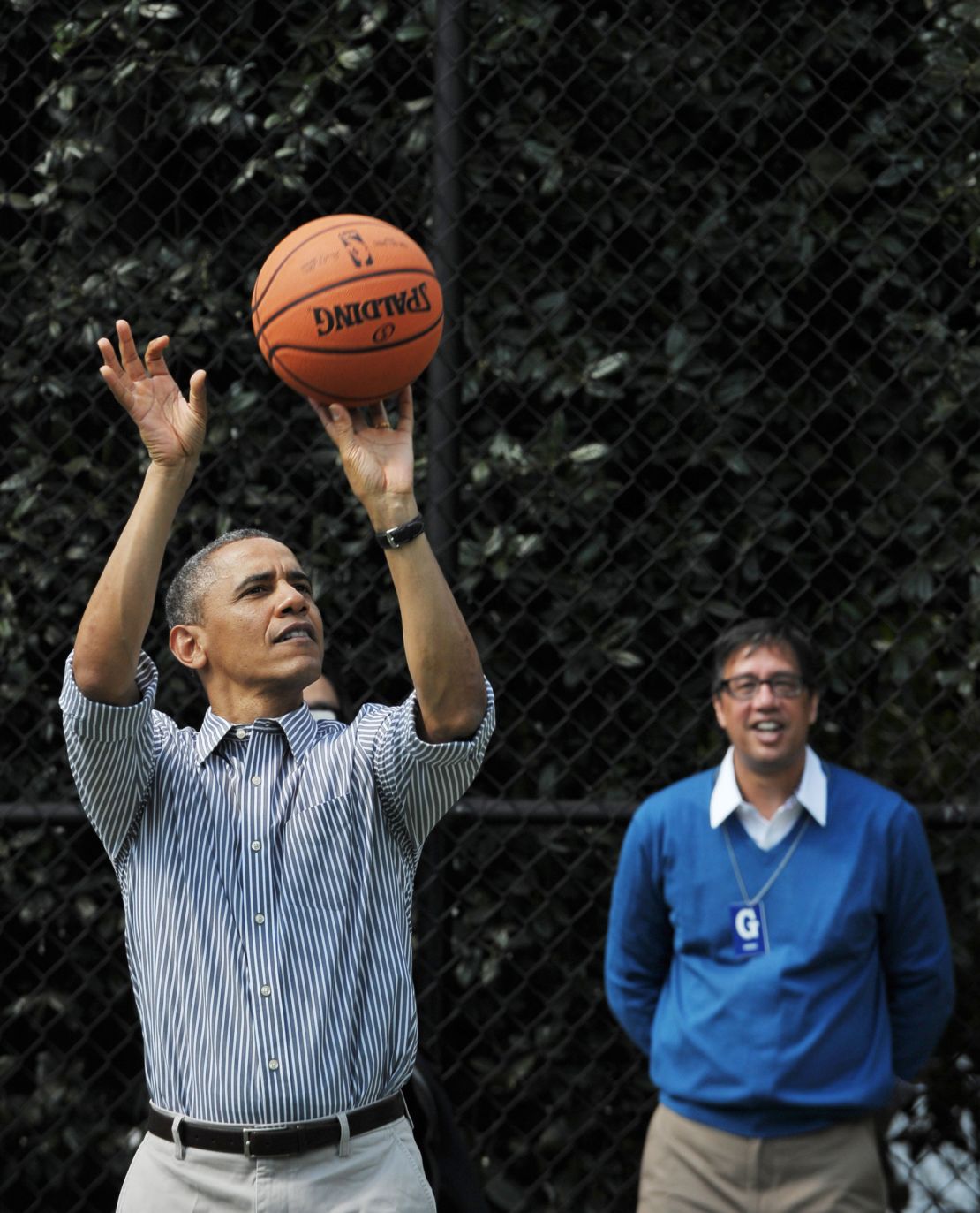 President Barack Obama shoots a basket as his friend Mike Ramos watches during the annual Easter Egg Roll on April 1, 2013, on the South Lawn of the White House.