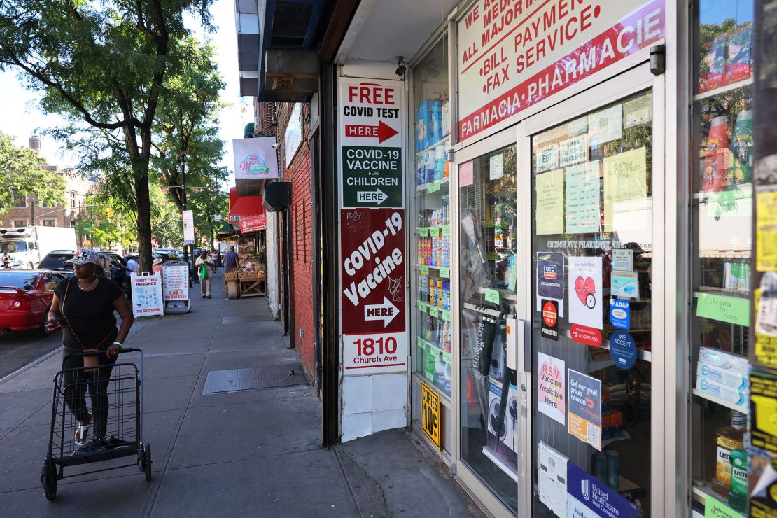 A sign for Covid-19 vaccines is seen on a door of a pharmacy in September 2023 in New York City.