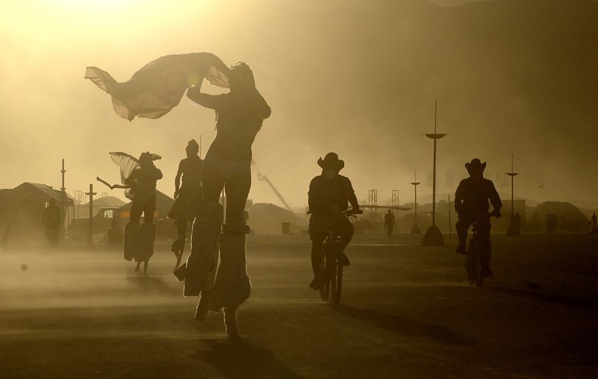 Burning Man events are held worldwide and burners often travel by bike, as seen in Black Rock City in 2005.
