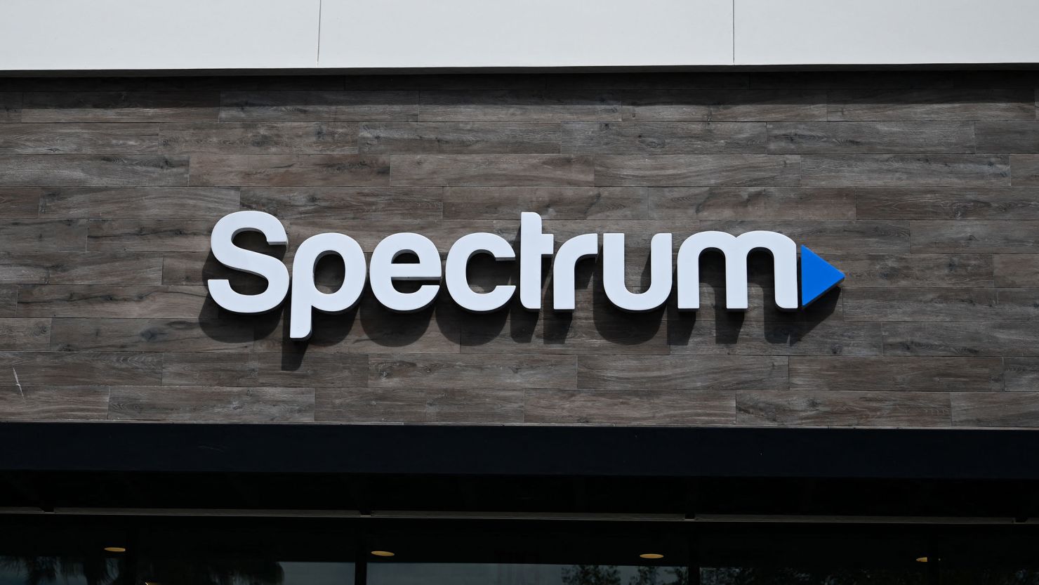 The Spectrum logo is displayed outside one of the company's stores in Manhattan Beach, California, in 2023.
