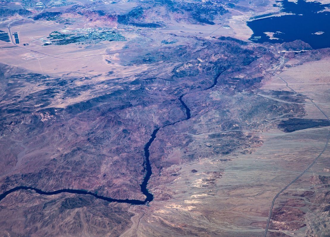 The Colorado River flows south from Hoover Dam and Lake Mead as viewed from a commercial flight on September 1, 2023, near Boulder City, Nevada.