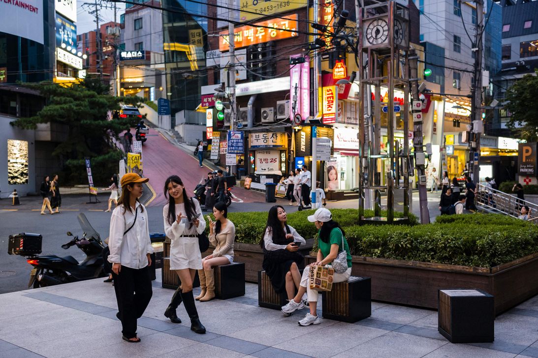People relax in a seating area in the Gangnam district of Seoul on September 14, 2023.