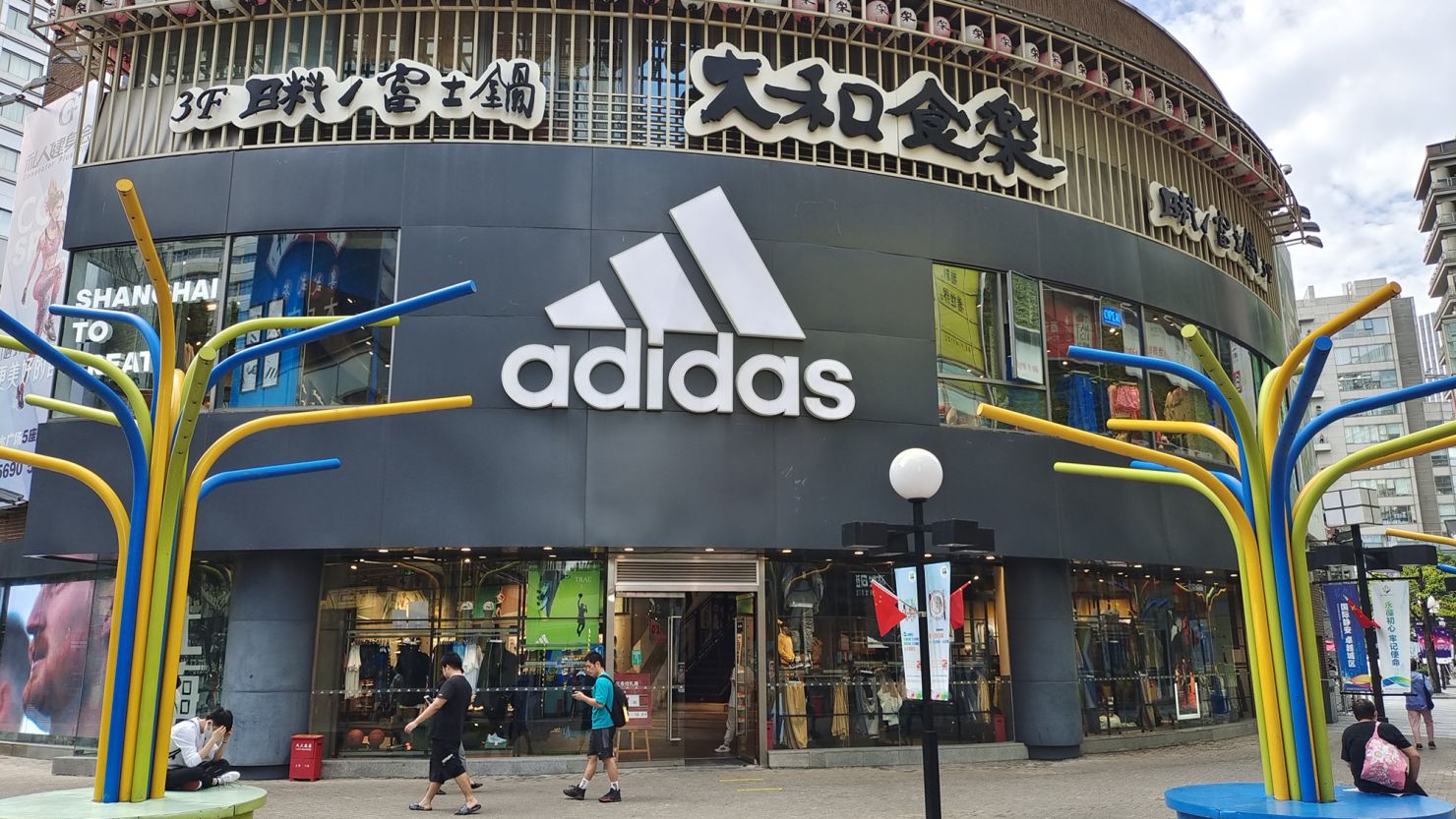 People walk past the flagship store of Adidas in Shanghai, China, on September 29, 2022.