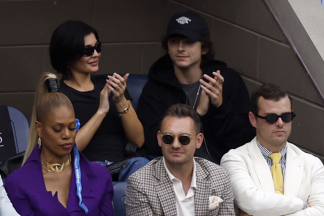 Kylie Jenner and Timothée Chalamet sit in an outdoor balcony at a suite at Ashe.