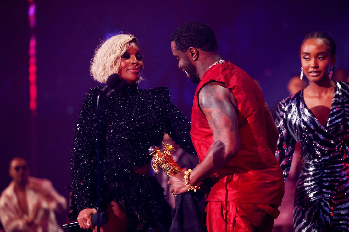 Sean Combs accepts the Global Icon Award from Mary J. Blige onstage during the 2023 MTV Video Music Awards.